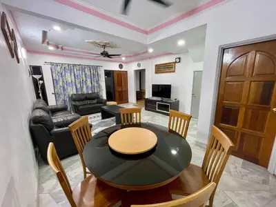 a dining room and living room with a table and chairs at Inap by KF in Bayan Lepas