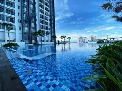 a pool in the middle of a building with blue tiles at Happy Home Metropol - BM in Bukit Mertajam
