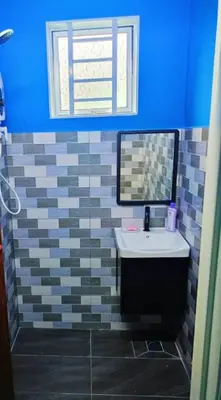 a bathroom with a sink and a mirror at The Batrisyia Homestay in TanjongMalim