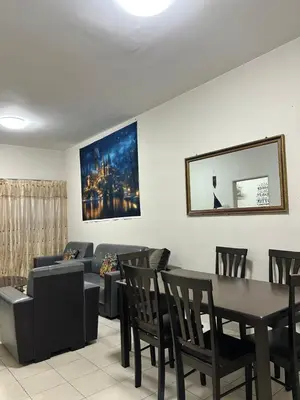 a living room with a couch and a table and chairs at Harry Potter Homestay Cameron Highlands in Tanah Rata