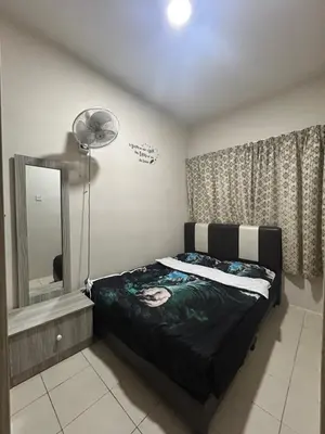 a bedroom with a bed and a mirror and a fan at Harry Potter Homestay Cameron Highlands in Tanah Rata