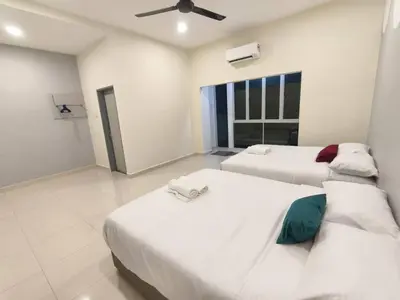 a bedroom with two beds and a window at Hello Pangkor Home 73A - A Nest for 12 buddies in Pangkor