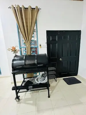 a black leather chair in a room with a door at Madam Cottage Homestay in Sungai Petani