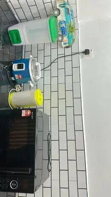 a bathroom with a tiled floor with a toy at Madam Cottage Homestay in Sungai Petani