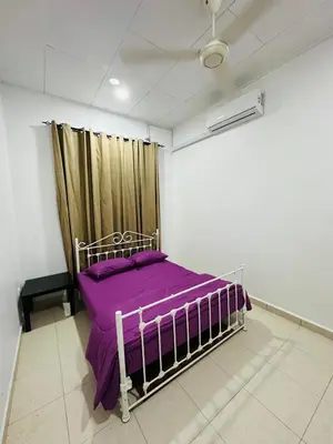 a bedroom with a bed with purple sheets and a curtain at Madam Cottage Homestay in Sungai Petani