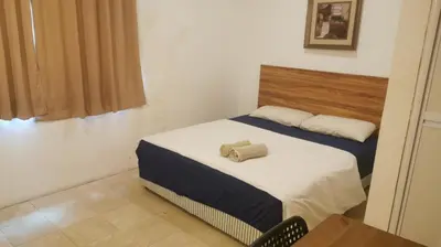 a bedroom with two beds in a room at NewTaunsHotel in Gua Sai