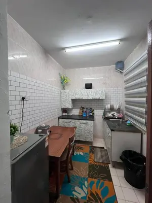 a kitchen with a table and a dining room at Dheaa's Homestay Cameron Highlands in Tanah Rata
