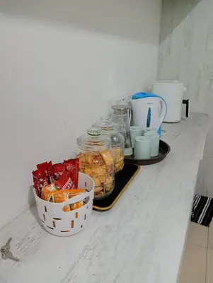 a counter with jars of food and cups on it at Ereens guest house Cameron highland in Brinchang
