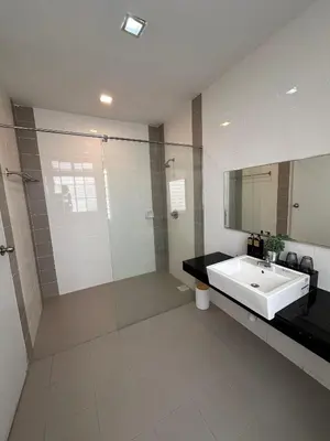 a bathroom with a sink and a glass shower at Shamrock By Island Hospitality in Batu Ferringhi