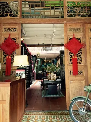 a room with a table and red chinese doors at You Le Yuen in George Town