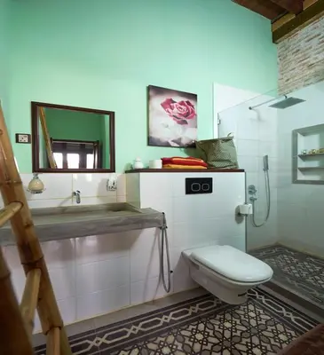 a bathroom with a toilet and a mirror at You Le Yuen in George Town