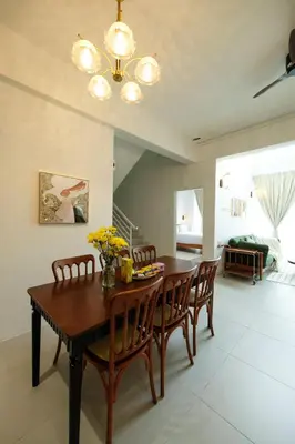 a dining room with a wooden table and chairs at Comfy Sofy-Bunny Vintage Penthouse in Tanah Rata