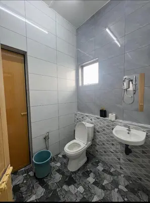a bathroom with a toilet and a sink at Intan Pearl Homestay in Teluk Intan