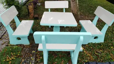 a blue picnic table and two white chairs at Sekinchan 231 VA Chalet in Sekincan