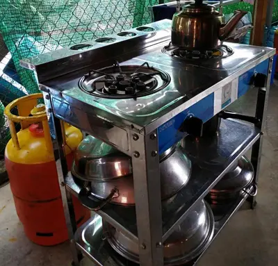a stove with a tea kettle on top of it at Sekinchan 231 VA Chalet in Sekincan