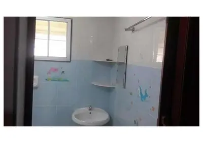 a bathroom with a toilet and a sink at Sekinchan 231 VA Chalet in Sekincan