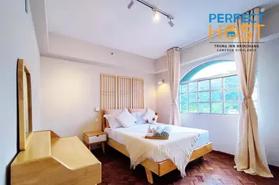 a bedroom with a bed and a window at Triima Inn Brinchang by Perfect Host in Brinchang