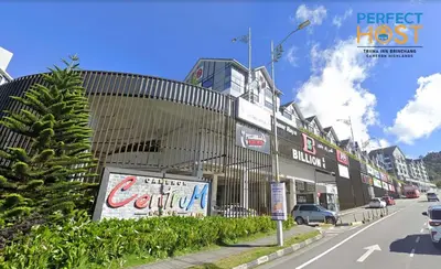 a building on a street with cars on the road at Triima Inn Brinchang by Perfect Host in Brinchang