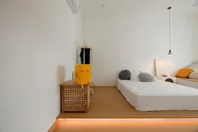a bedroom with two beds and a yellow object at Muji Style Minimalist Room Only NOT STUDIO in Bukit Mertajam