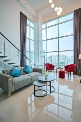 a living room with a couch and a table and chairs at Maritime Suite with Seaview 2BR - Water Dispenser - Dryer in George Town