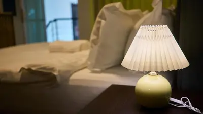a small lamp sitting on a table next to a bed at Maritime Suite with Seaview 2BR - Water Dispenser - Dryer in George Town
