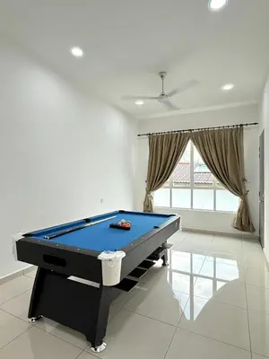 a pool table sitting in a living room with at Sekinchan 2008 Homestay KaraokeBBQ 20pax \u4e09\u5c42\u7b80\u7ea6\u98ce\u540d\u5bbf in Sekincan