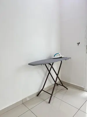 a table in the corner of a room with a white wall at Sekinchan 2008 Homestay KaraokeBBQ 20pax \u4e09\u5c42\u7b80\u7ea6\u98ce\u540d\u5bbf in Sekincan