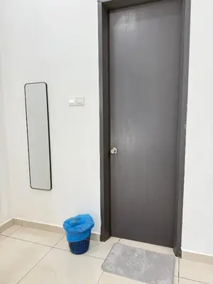 a door in a room with a mirror and a rug at Sekinchan 2008 Homestay KaraokeBBQ 20pax \u4e09\u5c42\u7b80\u7ea6\u98ce\u540d\u5bbf in Sekincan
