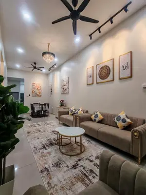a living room with couches and a ceiling fan at Seri Indah Homestay Bandar Baru Kuala Lipis in Kuala Lipis