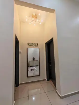 a hallway with a mirror and a chandelier at Seri Indah Homestay Bandar Baru Kuala Lipis in Kuala Lipis