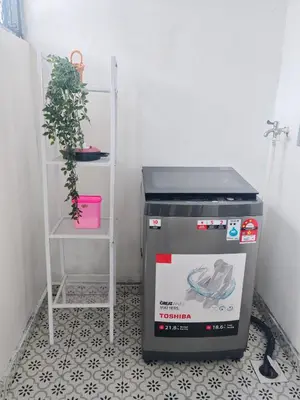 a small kitchen with a stove and a plant at Seri Indah Homestay Bandar Baru Kuala Lipis in Kuala Lipis