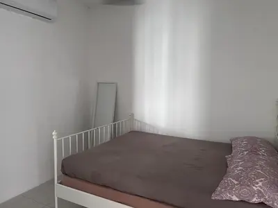 a bed in a white room with a mattress at Homestay Rumah Raban in Kampong Kuala Chegar