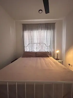 a large bed in a bedroom with a window at Homestay Rumah Raban in Kampong Kuala Chegar