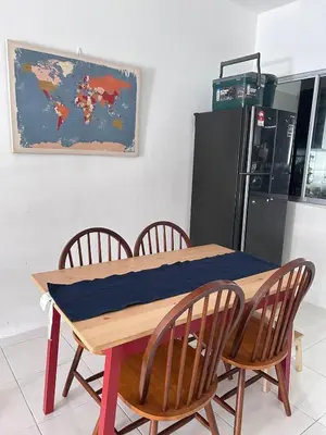 a dining room table with chairs and a map on the wall at Homestay Rumah Raban in Kampong Kuala Chegar