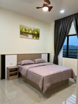 a bedroom with a bed and a ceiling fan at Highland Chill Retreat in Tanah Rata