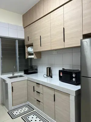 a kitchen with a sink and a microwave at Highland Chill Retreat in Tanah Rata