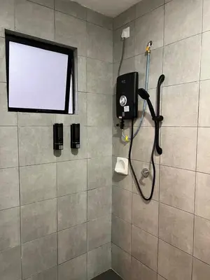 a bathroom with a shower with a shower head at Highland Chill Retreat in Tanah Rata