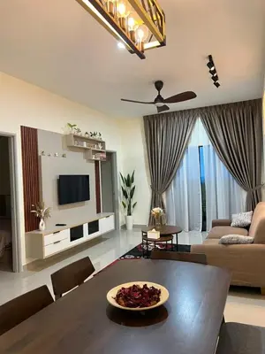 a living room with a table and a couch at Highland Chill Retreat in Tanah Rata