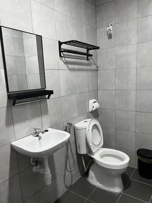 a bathroom with a toilet and a sink at Highland Chill Retreat in Tanah Rata