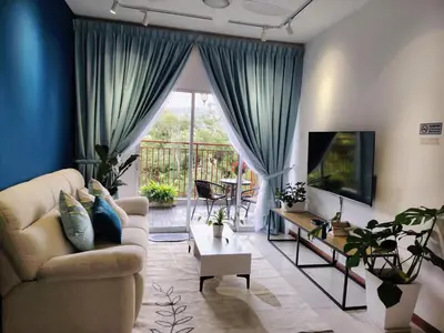 a living room with a couch and a tv at Hygee Home At Emerald Avenue Brinchang in Brinchang