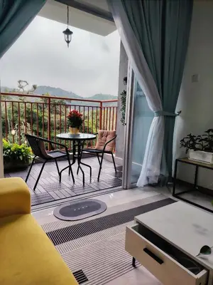 a living room with a balcony with a table and chairs at Hygee Home At Emerald Avenue Brinchang in Brinchang