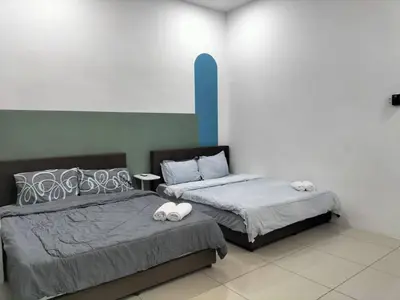 two beds sitting next to each other in a room at Cozy 4 bedrooms Double Storey Homestay, in front Kulim Central Mall in Kulim