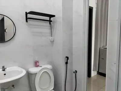 a white bathroom with a toilet and a sink at Cozy 4 bedrooms Double Storey Homestay, in front Kulim Central Mall in Kulim