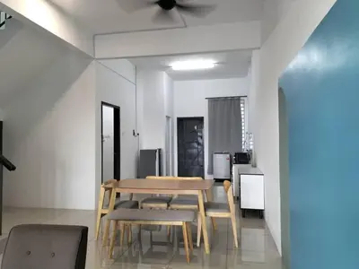 a dining room with a table and some chairs at Cozy 4 bedrooms Double Storey Homestay, in front Kulim Central Mall in Kulim