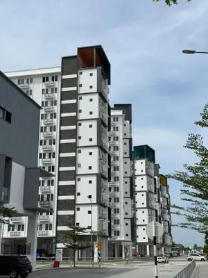 a tall white apartment building on a city street at The Cozy Loft in Kampar