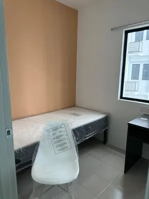 a small room with a bed and a window at The Cozy Loft in Kampar