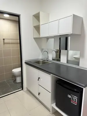 a bathroom with a sink and a toilet at The Cozy Loft in Kampar