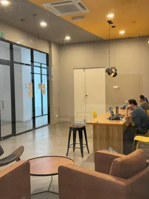 a group of people sitting at a desk in an office at The Cozy Loft in Kampar