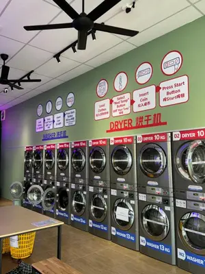 a row of washing machines in a laundry room at The Cozy Loft in Kampar
