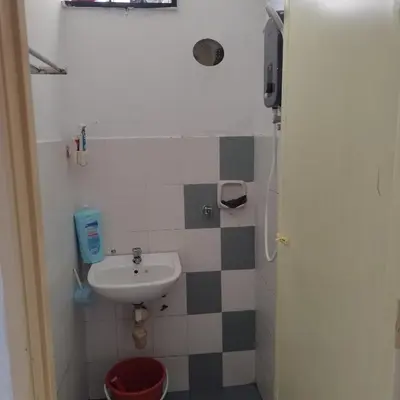 a small bathroom with a sink and a toilet at Mastermind Kemboja Homestay in Sungai Petani